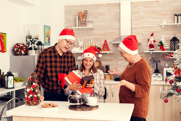 Cheerful grandchild enjoying christmas receiving presents