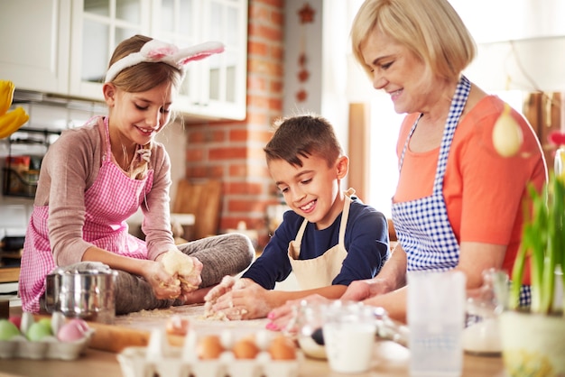 Cheerful grandmother with two little helpers