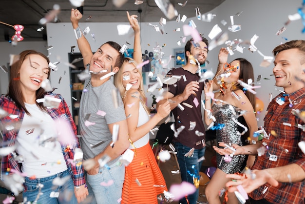 Cheerful guys in party. birthday party in confetti.