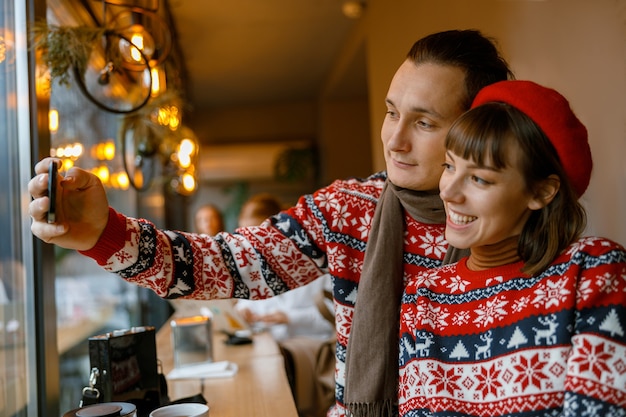 Cheerful happy and beautiful caucasian couple having date in a cafe