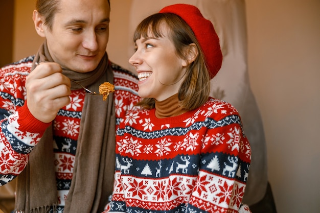 Cheerful happy and beautiful caucasian couple having date in a cafe