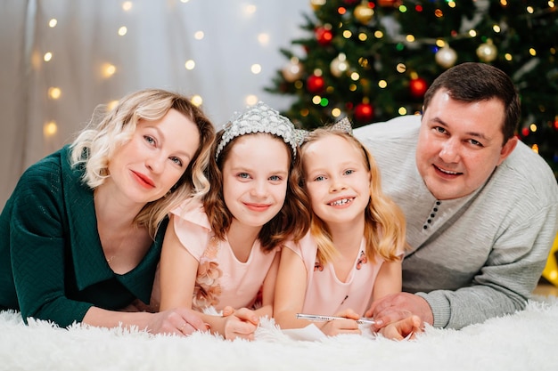 A cheerful happy family before the christmas tree