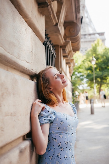 Cheerful and happy girl near the Eiffel Tower in Paris