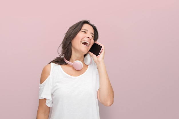 Cheerful happy smiling middle-aged woman talking on her phone