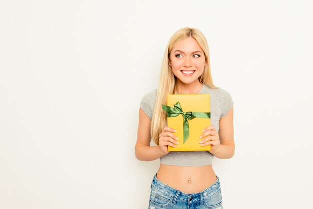 Cheerful happy woman with slim belly holding gift