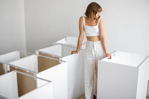 Cheerful housewife with new furniture in apartment