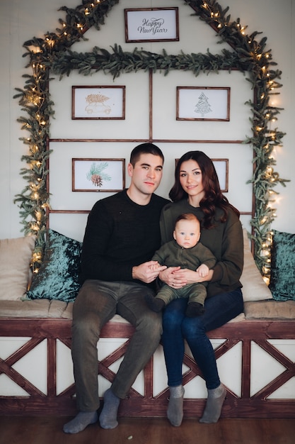 Cheerful and jovial beautiful family of three having fun