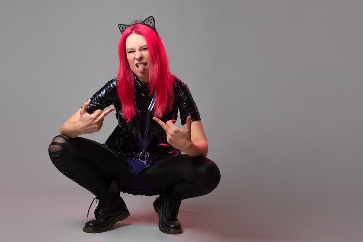 Photo a cheerful and kawaii bully with kitten ears, a young woman with pink hair squatted down
