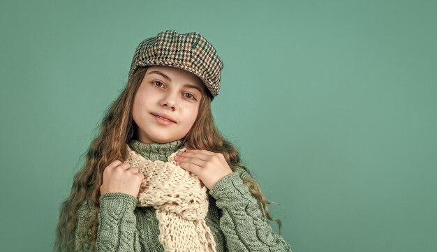 Cheerful kid girl in beret and knitwear copy space fashion