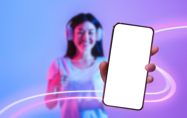 Cheerful korean lady enjoying newest musical mobile app mockup