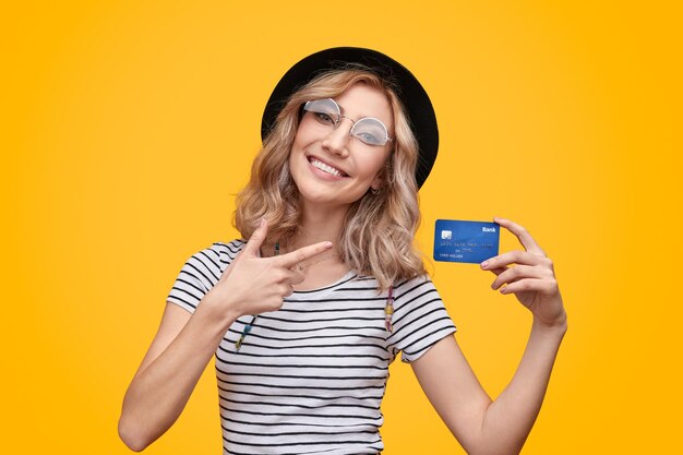 Cheerful lady pointing at plastic card