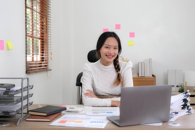 Cheerful lady working on laptop in home and use a computer\
laptop and thinking idea for her business