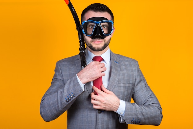 Cheerful laughing man in a business suit shows ok