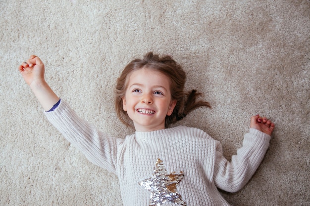 Cheerful little girl reaching for the stars