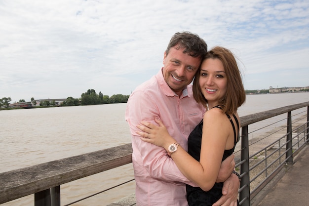 Cheerful and lovely couple outdoor by the river