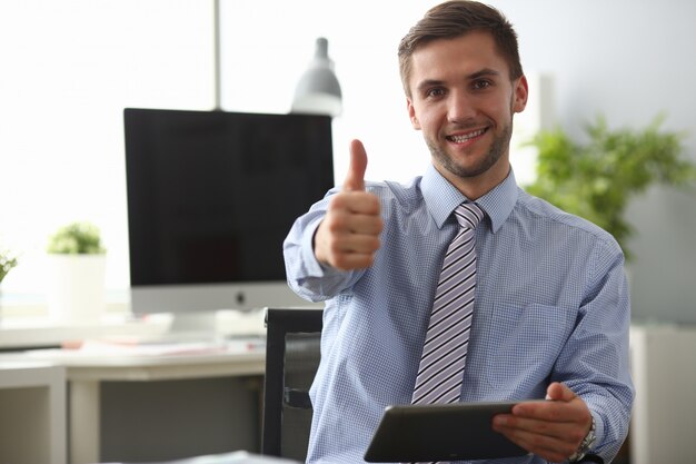 Cheerful male holding tablet