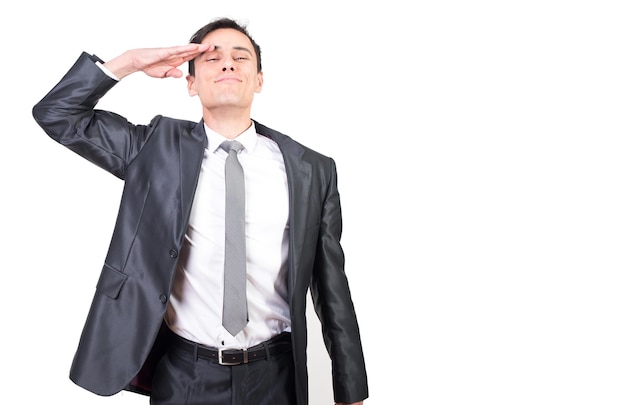 Cheerful male in suit saluting in studio