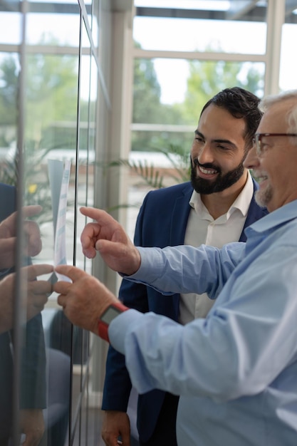 Cheerful males working in business center with pleasure