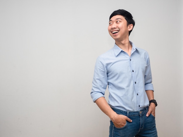 Cheerful man blue shirt happy smile turn around to looking at copy space