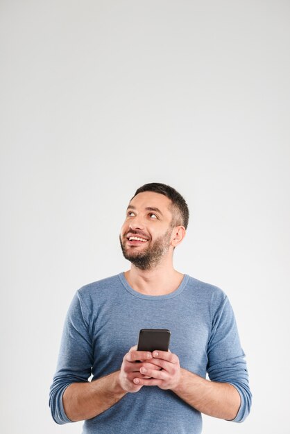 Cheerful man chatting by mobile phone.