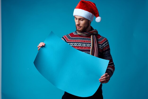 Cheerful man in a christmas blue mockup poster blue background