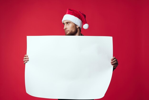 Cheerful man in a christmas white mockup poster red background High quality photo