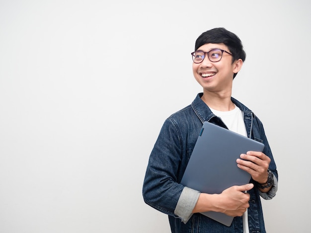 Cheerful man jeans shirt holding laptop smile turn face looking at copy space