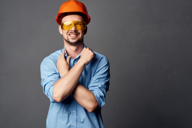 Cheerful man in orange hard hat construction safety tools