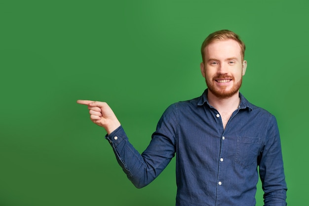 Cheerful man pointing with finger