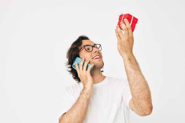 Cheerful man Red gift box telephone communication isolated background