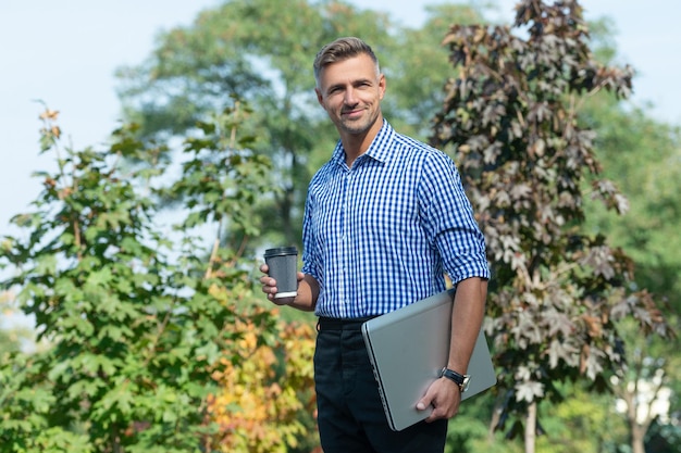 Cheerful man with coffee man freelancer drink coffee outdoor business man has coffee break