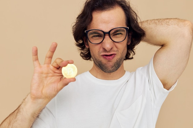 Cheerful man with glasses gold bitcoin in hands Lifestyle unaltered