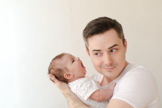 Cheerful man with screaming baby