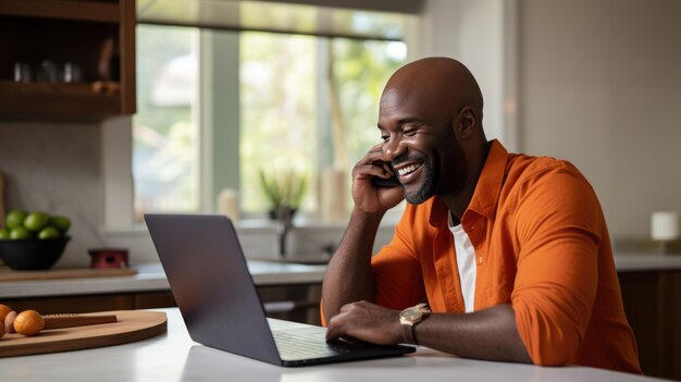 Cheerful man working on a laptop at home