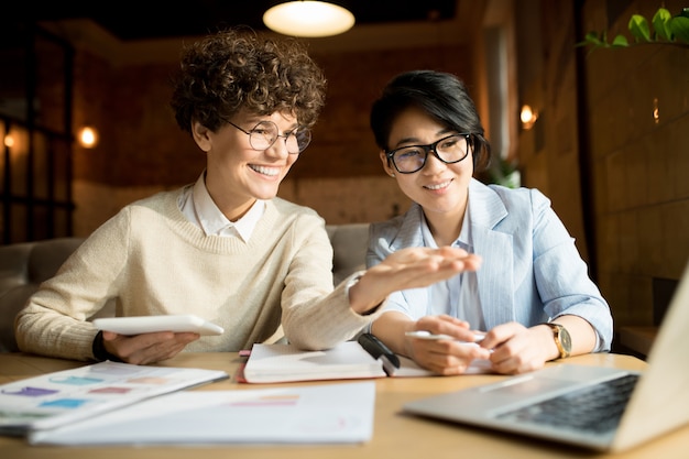 Cheerful marketing team analyzing information