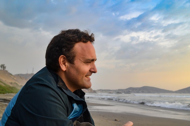 Cheerful mature Caucasian man looking at the sea