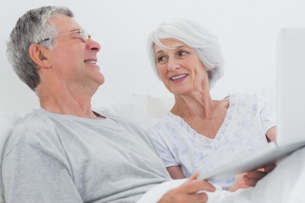 Cheerful mature couple using a laptop together