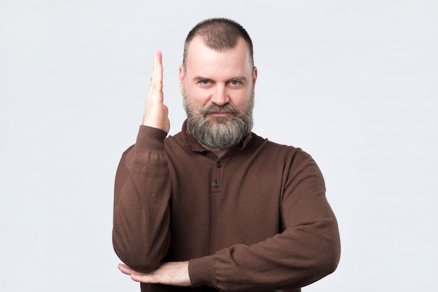 Cheerful mature man ready to answer question