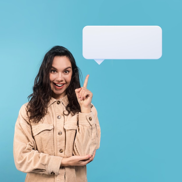 Cheerful millennial caucasian lady brunette student pointing at communication balloon