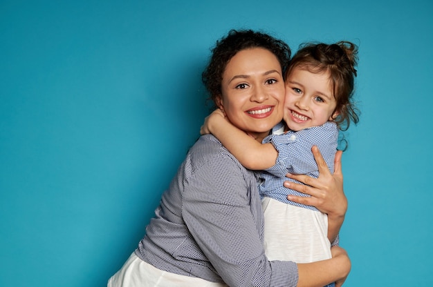 Cheerful mother hugging her daughter