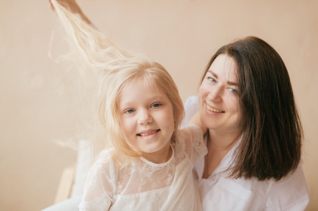 cheerful mother and little daughter have un