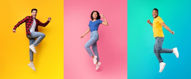 Cheerful Multiethnic People Jumping In Air On Colorful Backgrounds