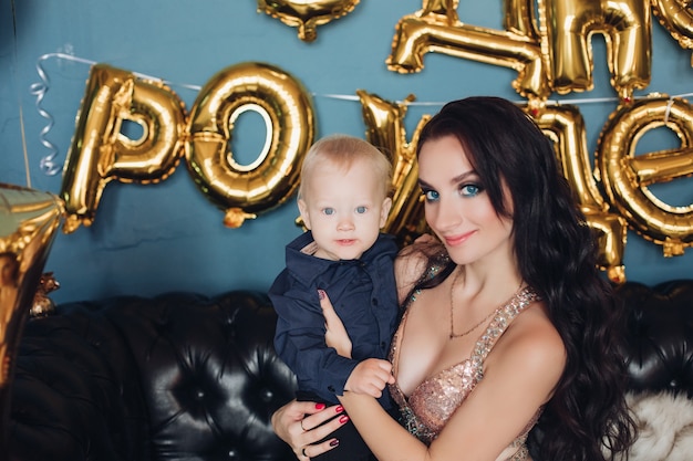 Cheerful mum with her pretty child in christmas atmosphere