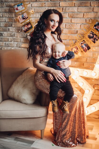 Cheerful mum with her pretty child in holiday atmosphere