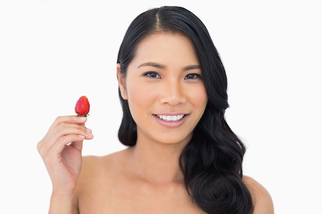 Cheerful natural brown haired model with strawberry