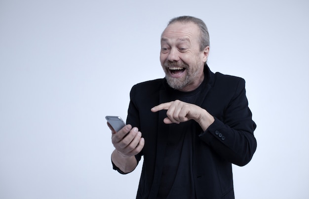 Cheerful old man talking on the phone.