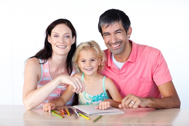 Cheerful parents and daughter smiling at camera