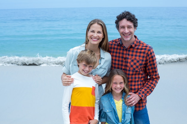 Cheerful parents with children standing on shore