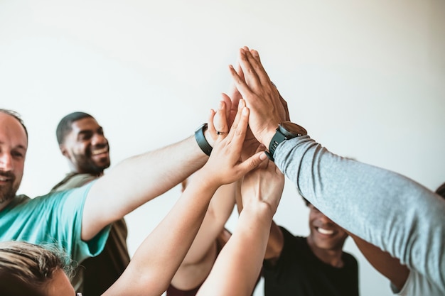 Photo cheerful people doing a group high five