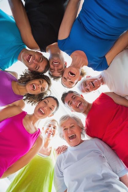 Foto gente allegra che forma huddle in palestra